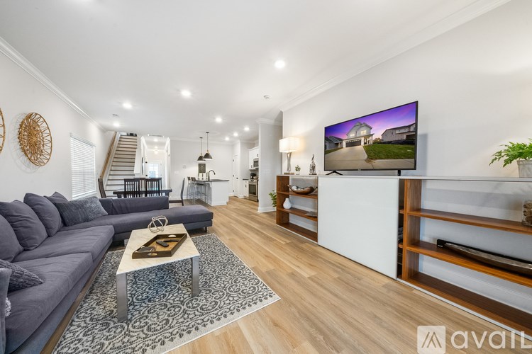 A modern living room with a grey sofa and a coffee table in the center.