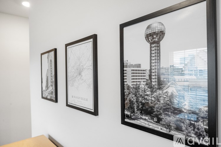 Three framed pictures hang on a wall.