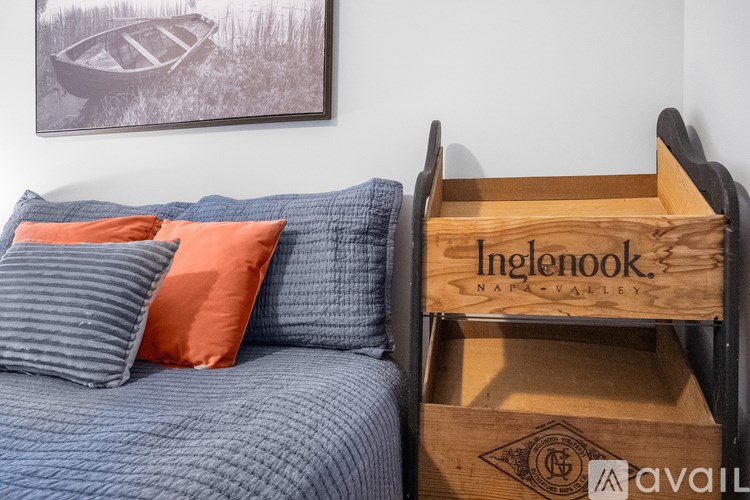 A bed with a wooden box on it that says Ingenook.