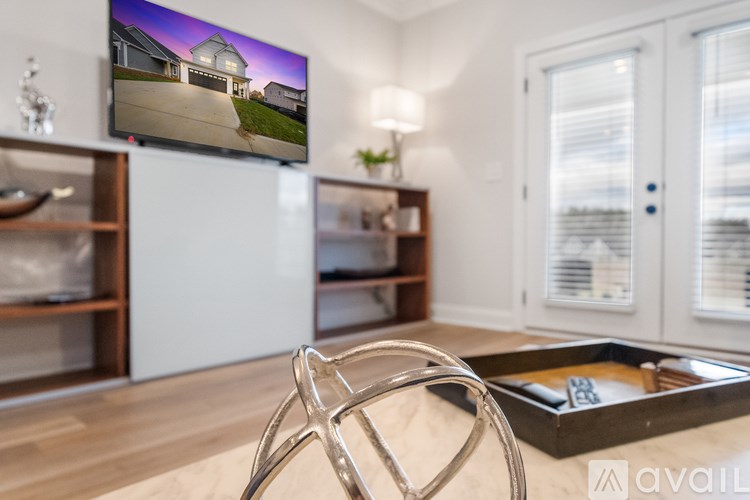 A modern living room with a flat screen TV mounted on the wall.