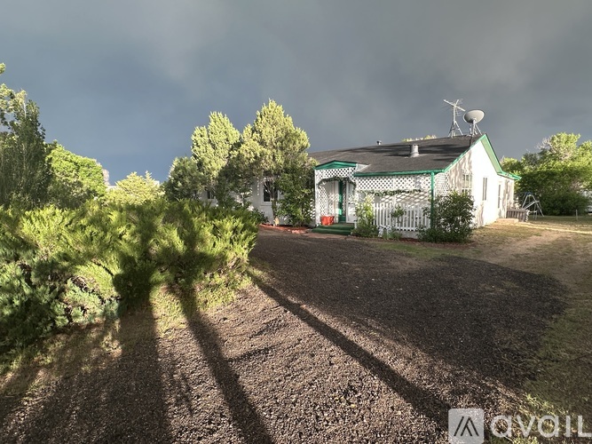 A fenced area with a house in the background.