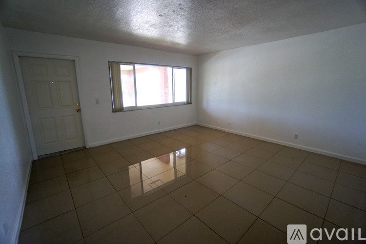 A room with a tiled floor and a window letting in light.