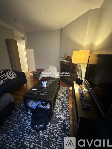 A living room with a black and white patterned carpet.