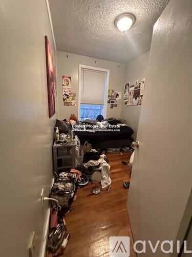 A hallway with a bedroom at the end.