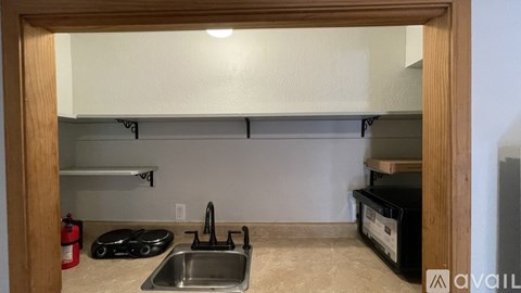 A kitchen with a sink and a stove top.