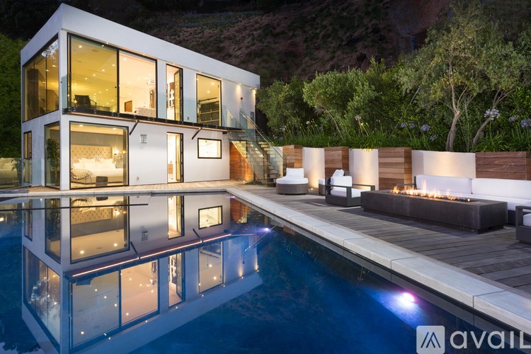 A modern house with a pool in the backyard.