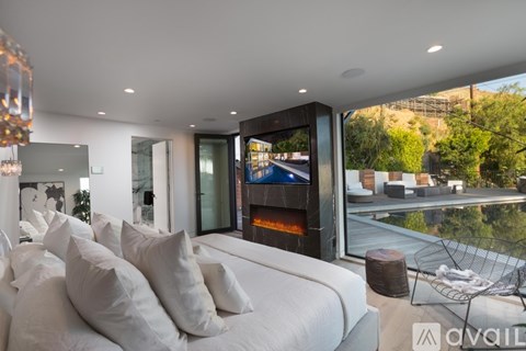 A modern living room with a large sofa and a fireplace.
