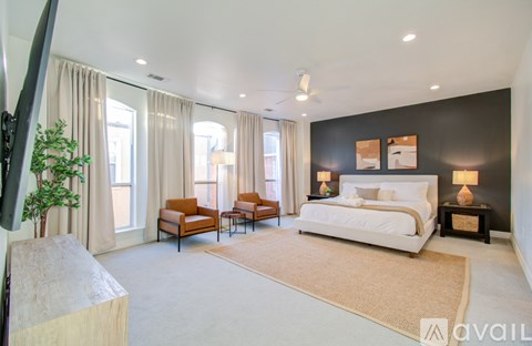 A bedroom with a large bed and a television on the left side.