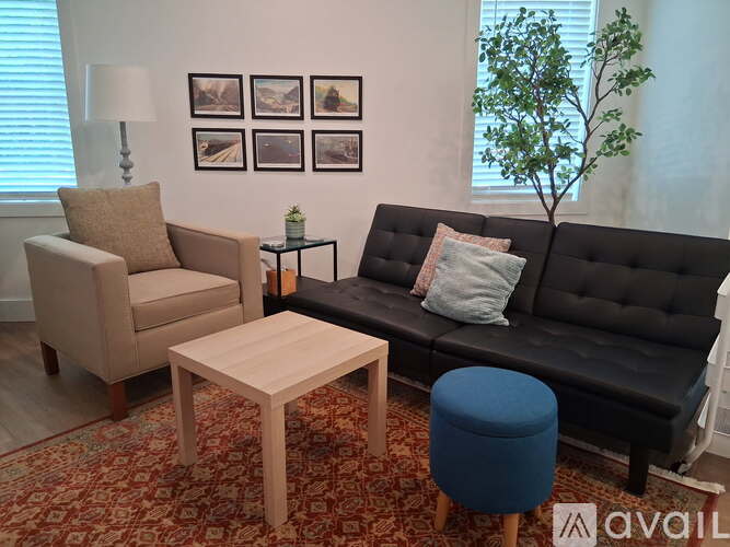 A modern living room with a dining table and chairs.