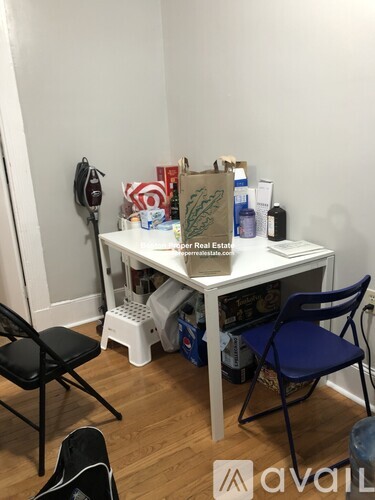 A small table with chairs and a sign that says "Real Estate" is in the image.