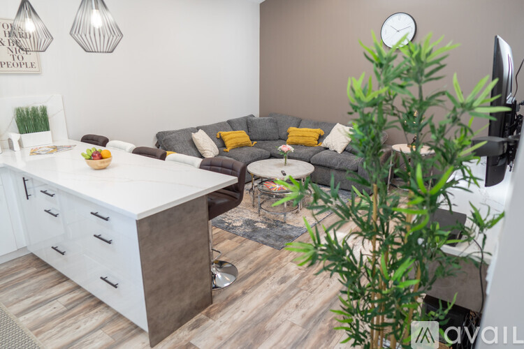 A living room with a grey couch and a white counter.