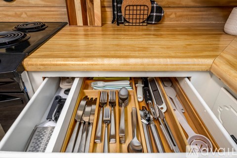A drawer full of silverware and utensils in a kitchen.