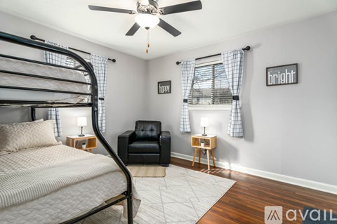A bedroom with a bunk bed and a chair.