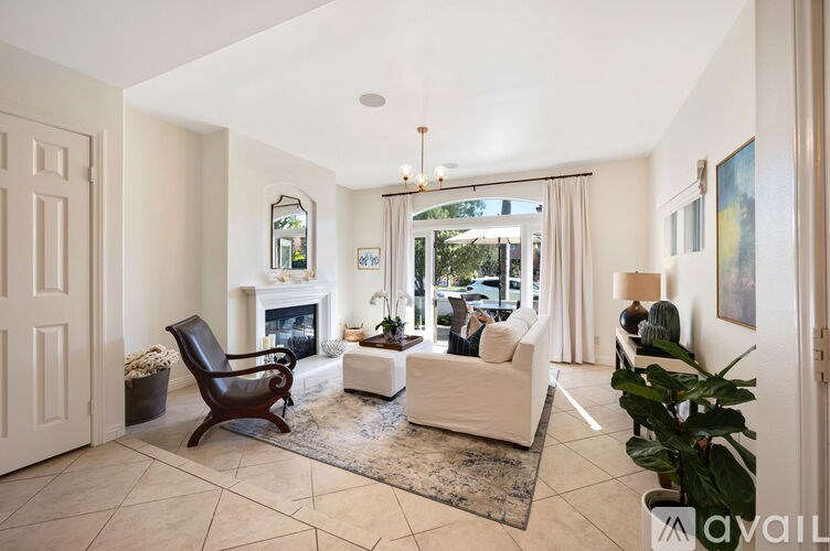 A living room with a fireplace and a chair.