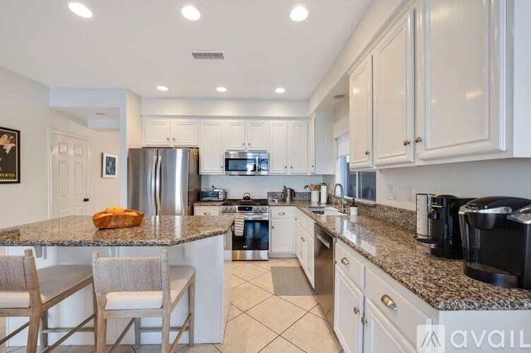A kitchen with granite countertops and stainless steel appliances.