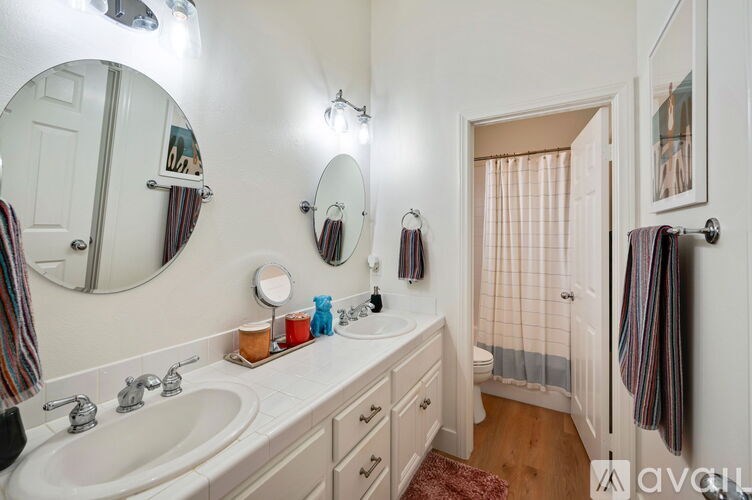 A bathroom with a white sink and a mirror above it.