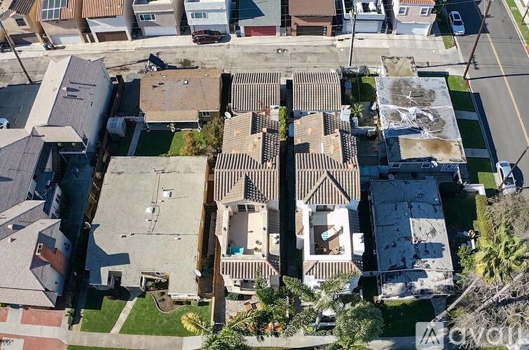 A bird's eye view of a residential area with houses and cars.
