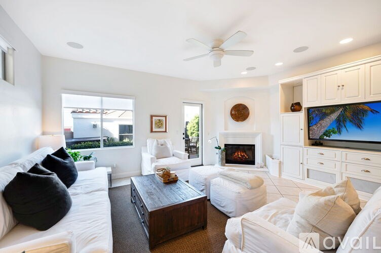 A living room with a fireplace and a television.