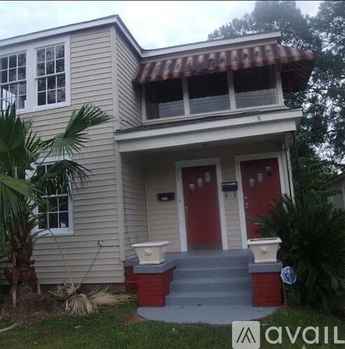A house with a red door and a brown roof.