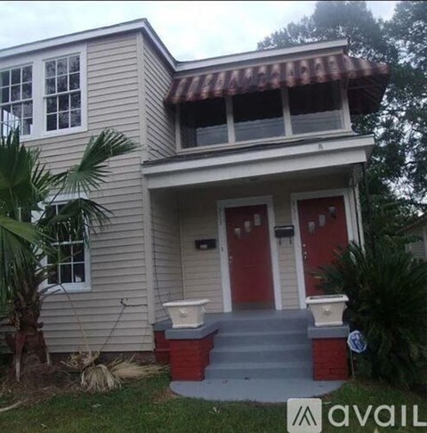 A house with a red door and a brown roof.