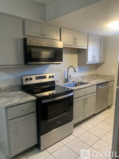 A kitchen with a stove top oven and microwave above it.