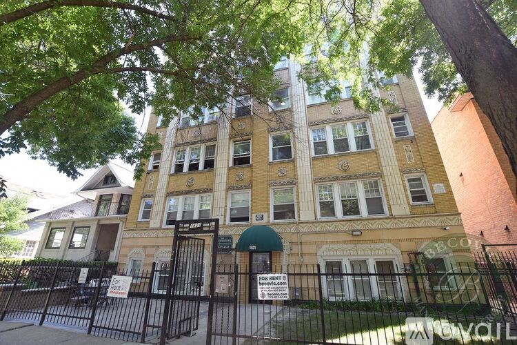 A building with a sign that says "For Sale" in front of it.