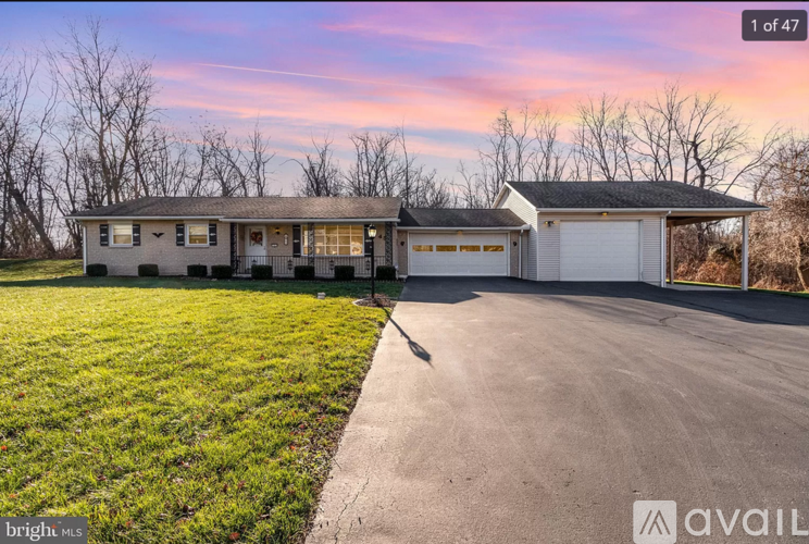 A house with a driveway in front of it is for sale.