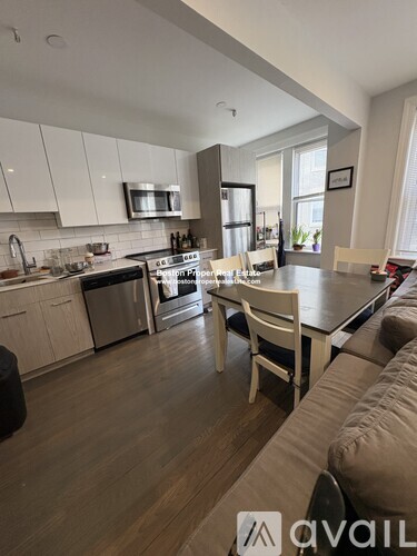 A modern kitchen with a dining table and chairs.