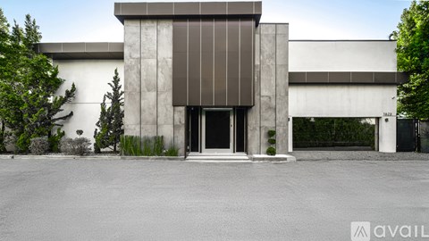 A modern house with a pool in front.