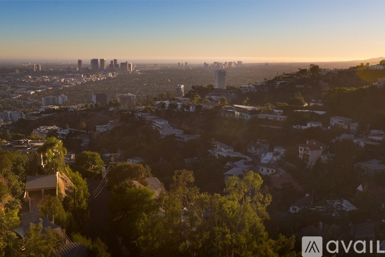 A cityscape with a clear sky and buildings in the distance.