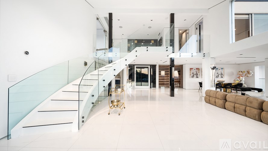 A city skyline at dusk with buildings illuminated against a darkening sky.