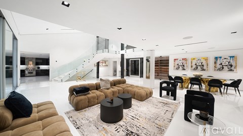 A modern dining room with a glass table and green chairs.