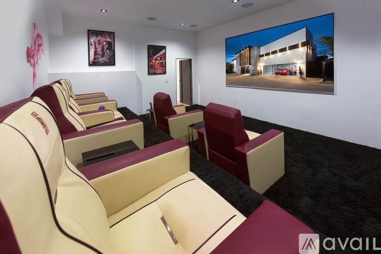 A room with a row of seats and a picture on the wall.