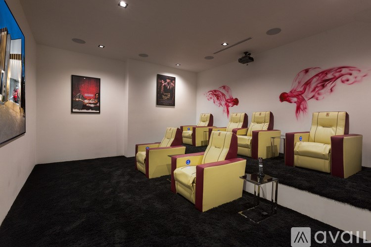 A room with yellow chairs and red artwork on the wall.