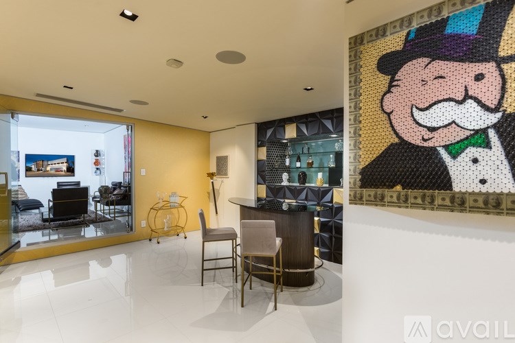 A living room with a large painting of a man in a top hat.