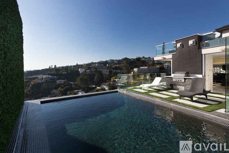 A modern house with a pool in the backyard.