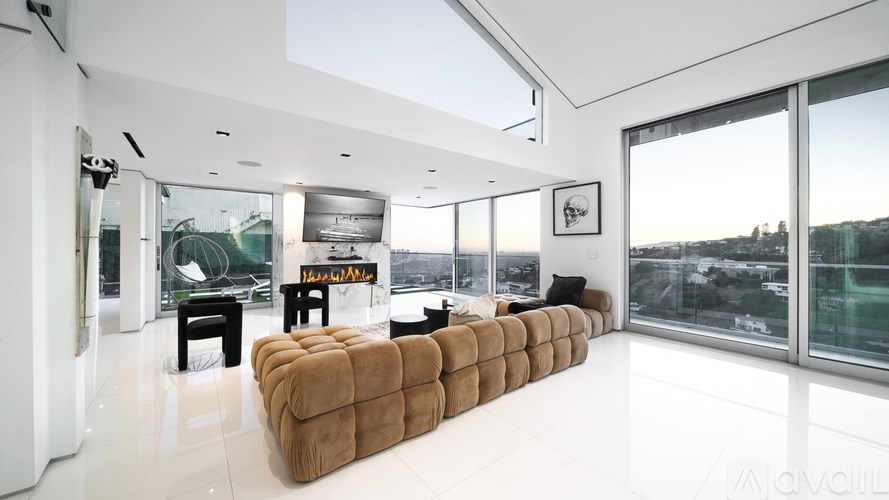A pool with a view of a city at sunset.