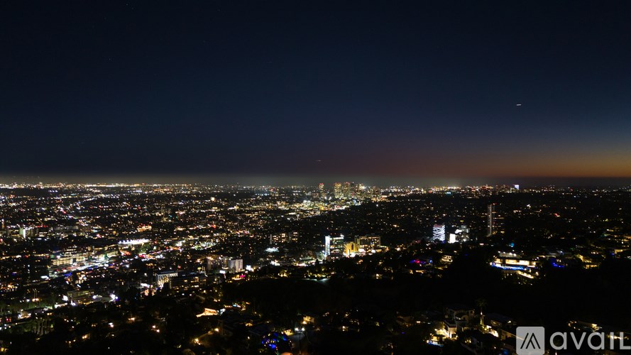 A cityscape at night with a clear sky.