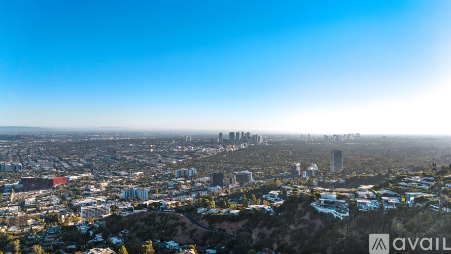 A cityscape with a clear blue sky above it.