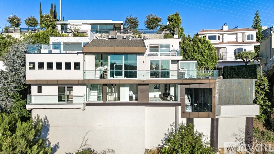 A modern house with a flat roof and large windows.
