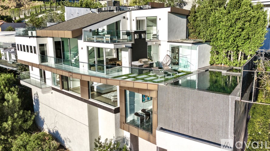 A modern house with a glass balcony.