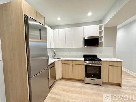 A modern kitchen with wooden cabinets and stainless steel appliances.