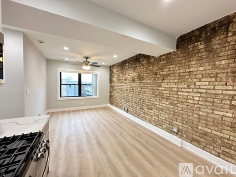 A room with a brick wall and a wooden floor.