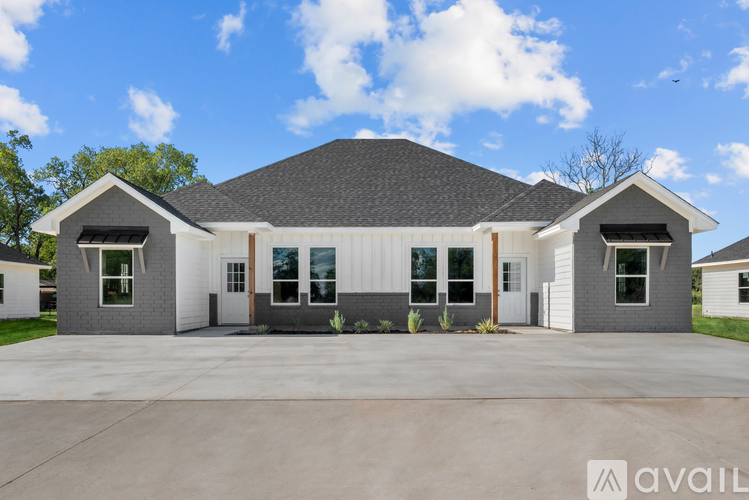 A modern house with a large front yard is available for purchase.