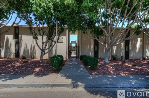 A building with a tree in front of it.