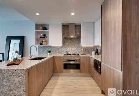 A modern kitchen with wooden cabinets and stainless steel appliances.