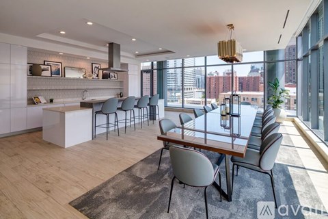 A modern dining room with a long table and chairs.