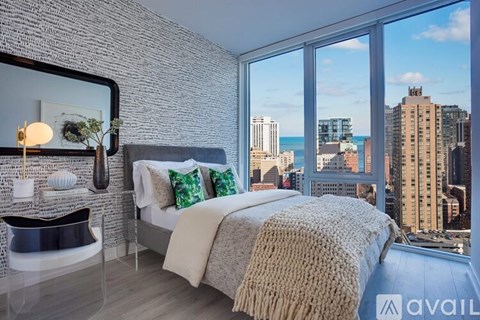A bedroom with a large bed and a view of the city.