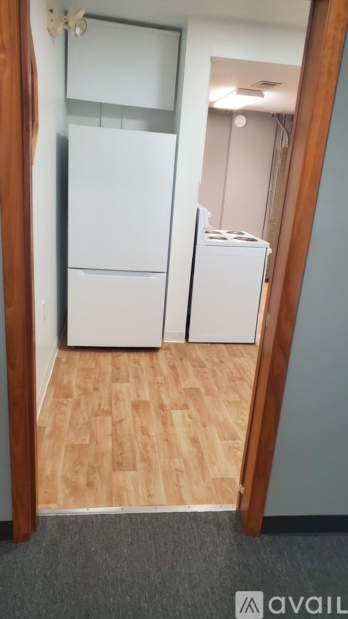 A kitchen with a white fridge and a white dishwasher.