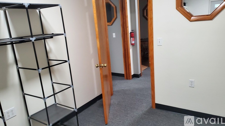 A tall black shelf unit stands against a white wall.